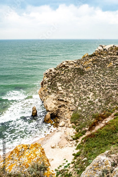 Obraz Mountains of steel and stones on the seashore. Wild beach. holidays, privacy, 