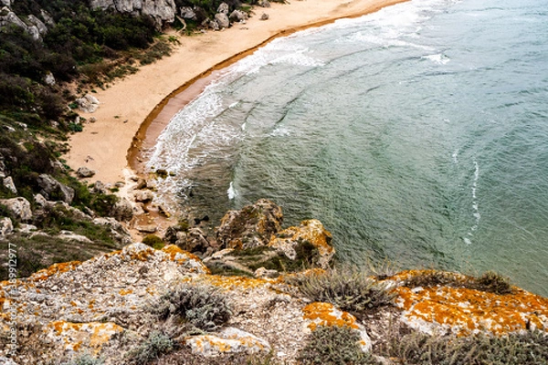Obraz Mountains of steel and stones on the seashore. Wild beach. holidays, 