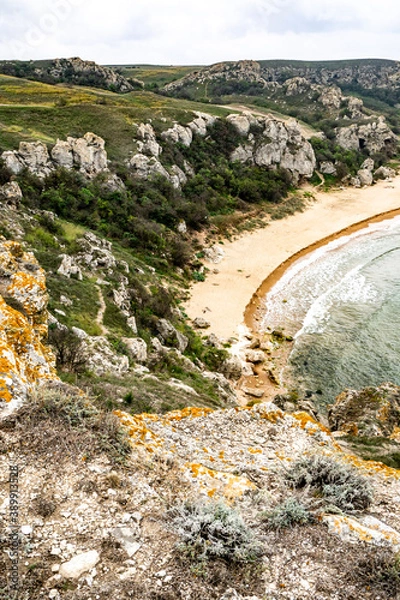 Obraz Mountains of steel and stones on the seashore. Wild beach. holidays, privacy, 