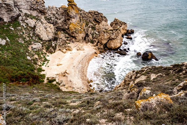 Obraz Mountains of steel and stones on the seashore. Wild beach. holidays, privacy, 