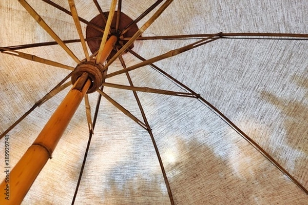 Fototapeta In the shade of canvas umbrella