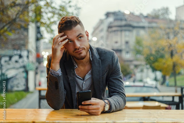 Obraz a worried man with a cell phone