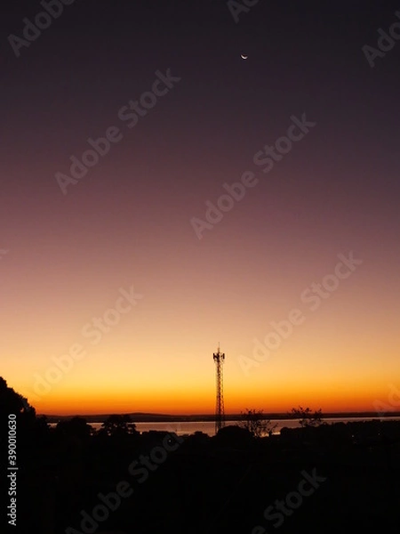Obraz sunset over the city. Sky purple and moon.