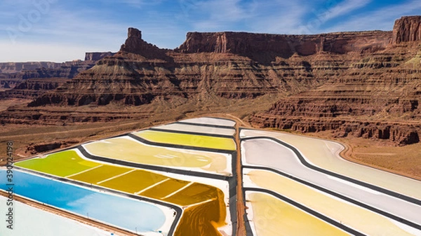 Fototapeta Aerial view of potash ponds near Moab Utah. The ponds have an array of colors in the middle of the red desert rock landscape. Ponds are used to extract salt.