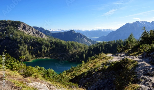 Fototapeta Wonderful vacations on the region Salzkammergut in Austria, Eur; hiking on the waterside  of the six lakes on the Tauplitz-Alm (alpine pasture); panoramic view with hills and reflections on the water.