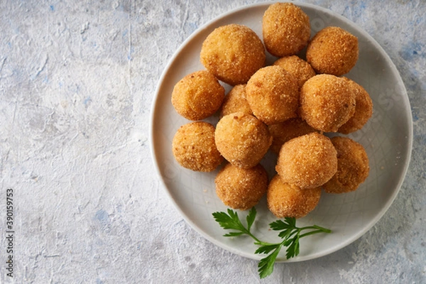 Obraz Fried cheese balls, appetizer with herbs and sauces in a plate on a gray table Copyspace