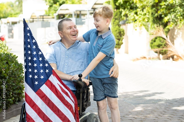 Fototapeta Disabled father with flag of USA smiling to his son