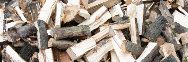 Fototapeta Banner. Heap of chopped firewood background. Pile of split firewood. Stack of fuel wood