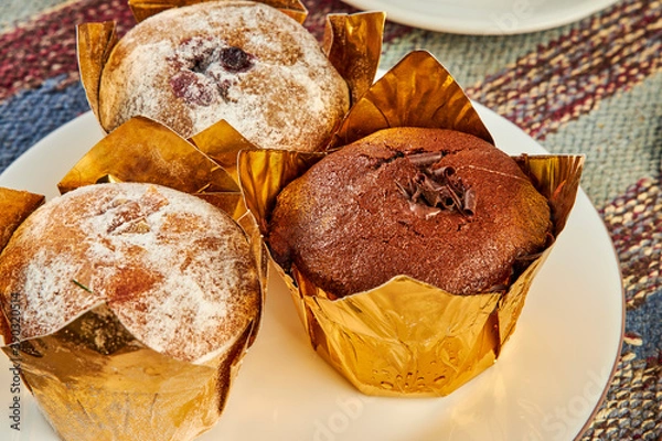 Fototapeta coffee and muffins on table in cafe close up