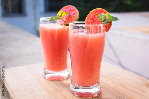 Obraz Close up shot of glass of organic Guava juice with fresh guava