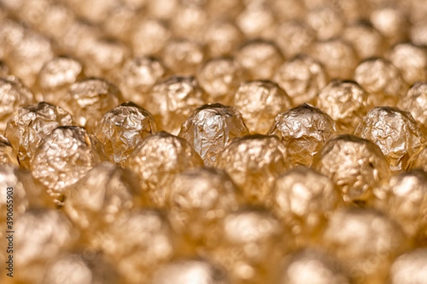 Obraz a lot of round candy wrapped in gold foil closeup