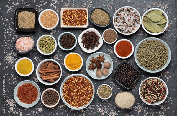 Fototapeta Assortment of aromatic spices and herbs in small bowls 