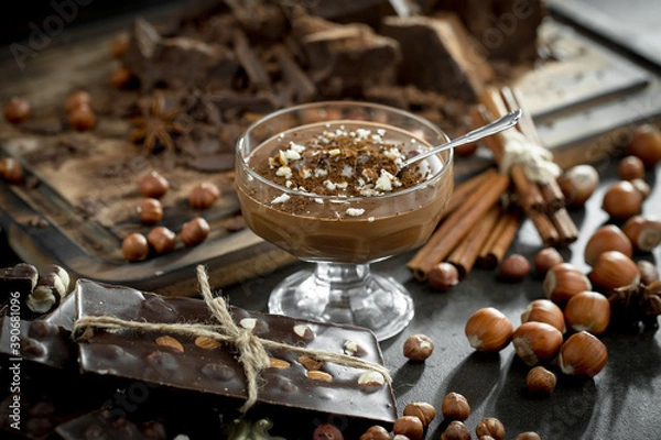 Fototapeta Dark chocolate in a composition with cocoa beans and nuts, on an old background.