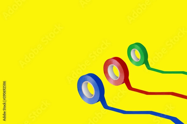 Obraz Different color electrical tapes on yellow background
