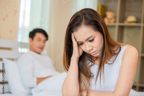 Fototapeta Young asian woman sad and depressed in bed sleepless late night feeling desperate looking worried and anxious suffering depression problem and insomnia sleeping disorder.