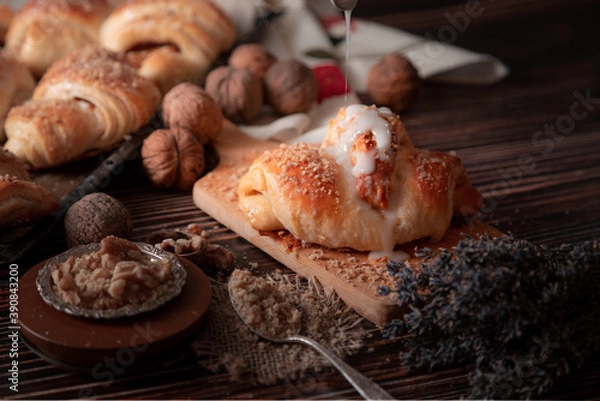 Fototapeta A croissant surrounded by other sugar-coated croissants