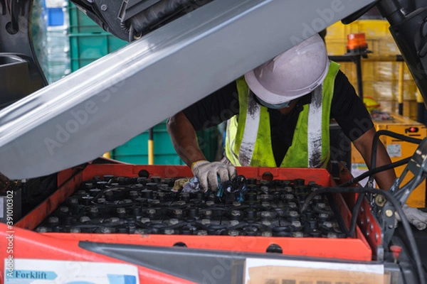 Obraz Battery maintenance technician forklift from hard work factory Inspection Engineer Check on time propane