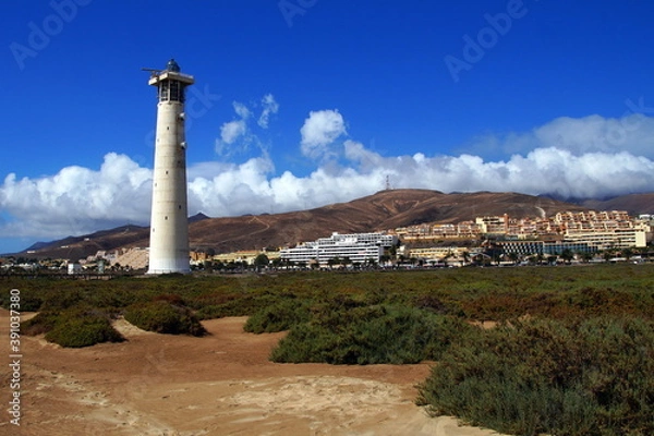 Obraz Lighthouse at Jandia Beach, Fuerteventura, against a partly clouded sky.
