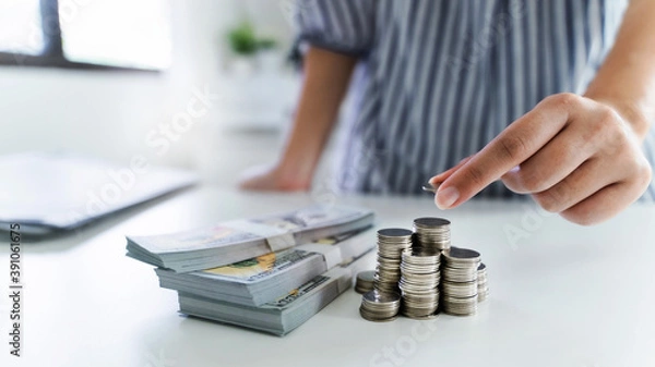 Obraz Business person holding and stacking coins on the table, future investment, retirement.