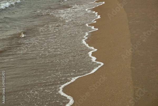 Obraz Surf with a surfacing wave bordered by foam