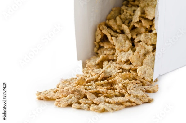 Obraz Box of cornflakes with content spilled onto a table