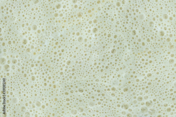 Fototapeta The texture of the frothed milk. Foam. Bubbles.