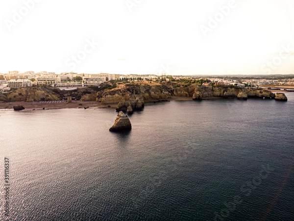 Obraz Rocky sandy bay among cliffs on a sunset