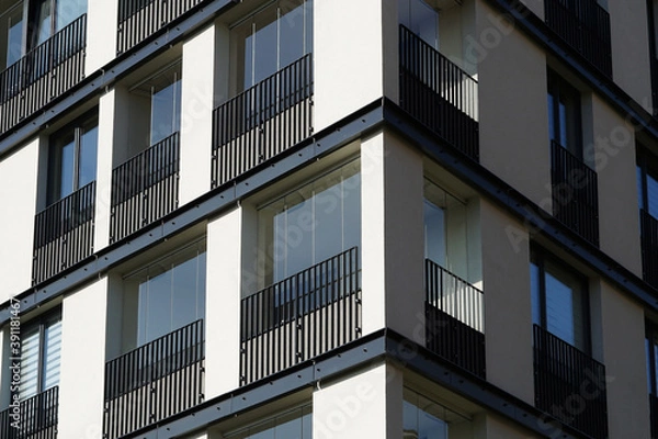 Fototapeta Modern residential or office building with large windows, close-up view concept