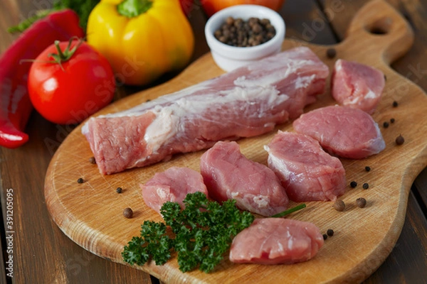 Obraz pork tenderloin on wooden surface