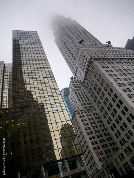 Fototapeta Canted shot of skyscrapers in New York City, Top of the building in the sky, Manhattan in the mist, Haze in the city, Autumn weather