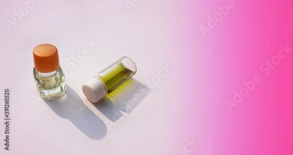 Fototapeta two small perfume or attar bottles isolated in white background with selective focus