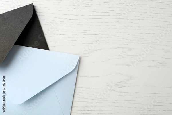 Fototapeta Paper envelopes on white wooden background, flat lay. Space for text
