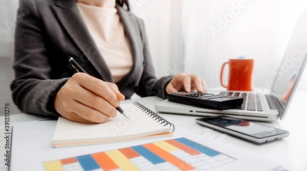 Fototapeta businesswoman hand using smart phone, tablet payments and holding credit card online shopping, omni channel, digital tablet docking keyboard computer at office in sun light