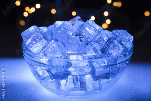 Obraz Bowl of wet ice with garlands in the background
