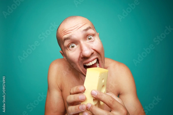 Obraz A funny bald man holding fresh cheese isolated on green background