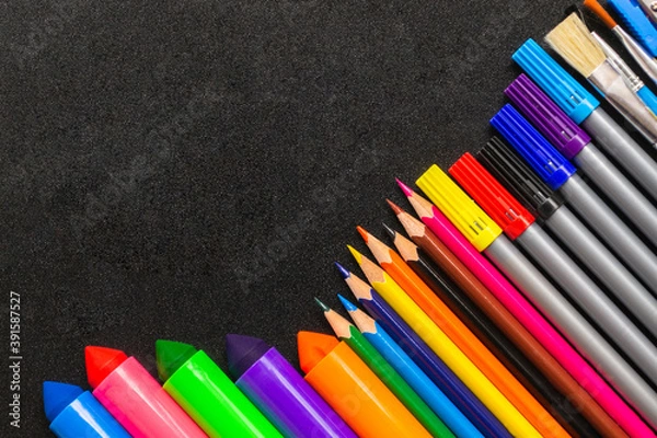 Fototapeta Frame from pencils and felt-tip pens on chalk background. Back to school and new academic year concept. Copy space, place for text.