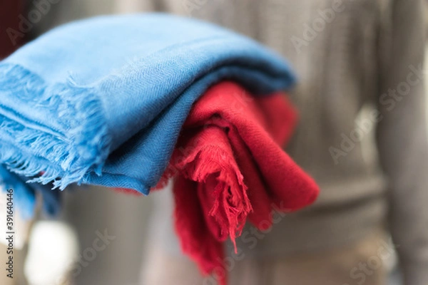 Obraz close up of colorful scarf, Close up blue and red cashmere textile clothes, woollen piece of fabric,  soft focus, blurred bokeh on a grey background