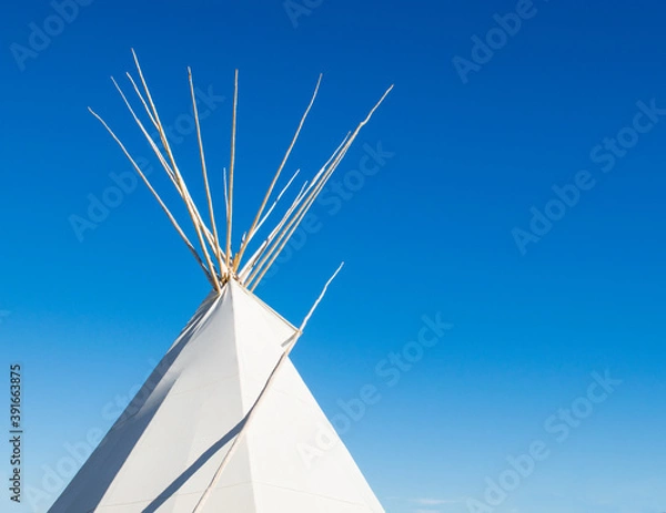 Obraz a Native American tipi under bright blue skies with copy space