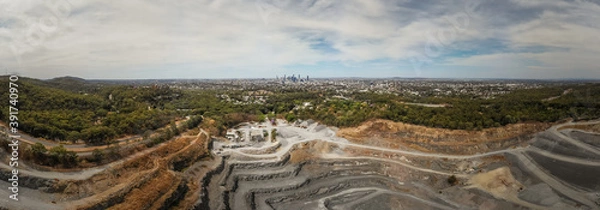 Fototapeta Panorama of a quarry with the city in the background