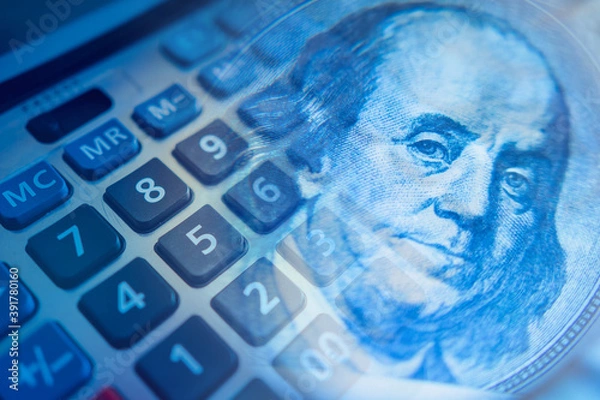 Fototapeta Podschet money. Calculator keys next to franklin portrait. Concept - accounting services. Fragment of a calculator close-up. Concept - personal finance. Financial analysis. Analysis personal expenses