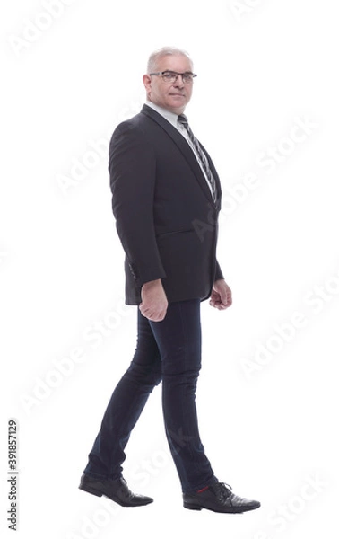 Fototapeta side view. confident business man striding forward