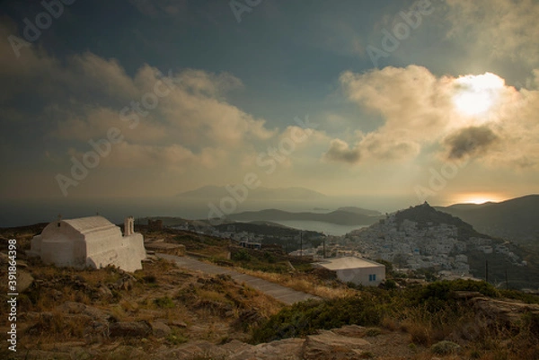 Fototapeta View at Ios main village or Chora at sunset time from a viewpoint in the mountain above, Ios island, Greece