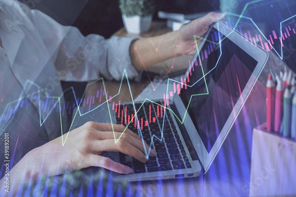 Obraz Double exposure of woman hands typing on computer and forex chart hologram drawing. Stock market invest concept.