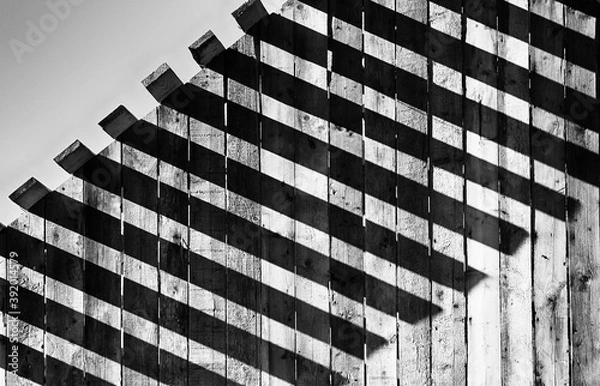 Obraz Light and shadow concept, The sunlight shines through the wooden awning on the wall, Abstract background.