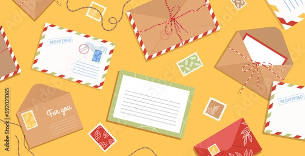Fototapeta Envelope, letters, stamps and postcards on the table. Workspace with flat style postage elements. Background with greeting cards and blank hand drawn.