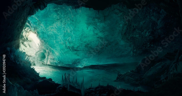 Obraz Beautiful ice cave background with a man (explorer) discovering the cave.