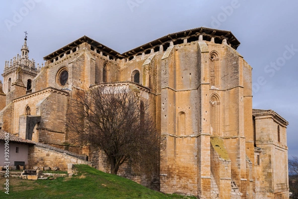 Obraz old gothic style catholic church back view with a dramatic sky in palencia, spain
