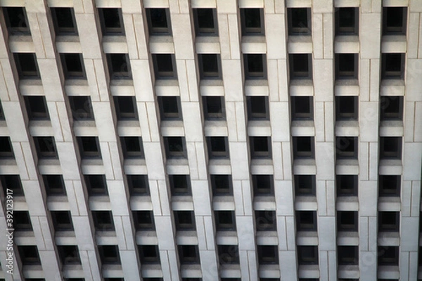 Fototapeta The regular windows pattern in a concrete building