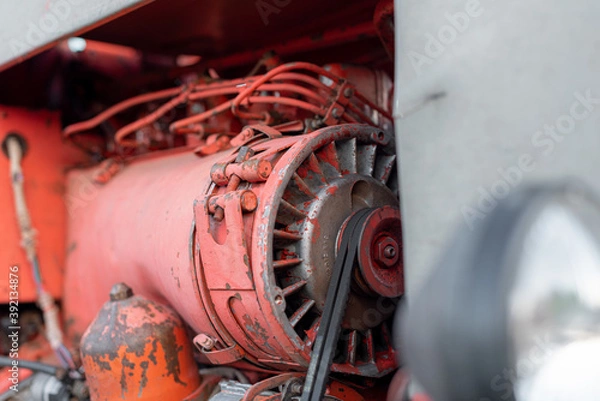Fototapeta Closeup of red tractor fuel injectors four cylinder diesel engine details on sharp focus in rural Bulgarian region in autumn