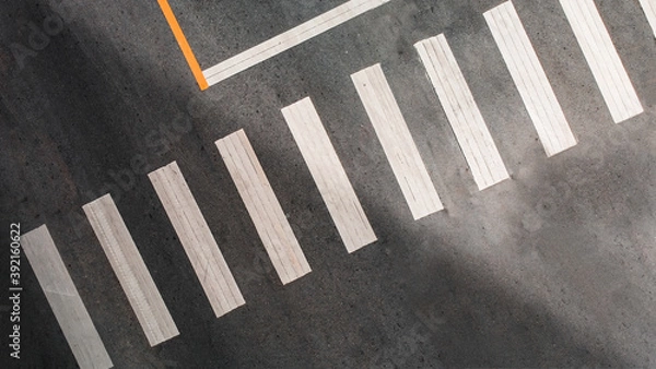 Fototapeta aerial view of abstract crosswalk on asphalt road. no people. copy space.